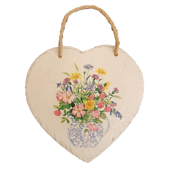 A heart-shaped slate plaque with a floral design in a blue and white vase hanging from natural twine