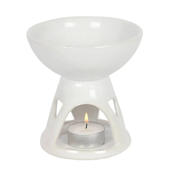 White ceramic deep bowl oil burner with geometric cutouts and lit tealight candle inside