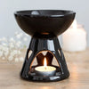 Deep bowl ceramic oil burner in black with glossy finish and heart-shaped cutouts around the base