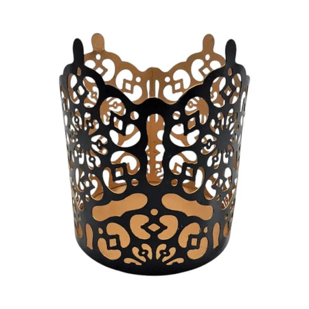 Black metal votive candle holder with intricate die-cut patterns showing warm gold interior prussian style metal votive