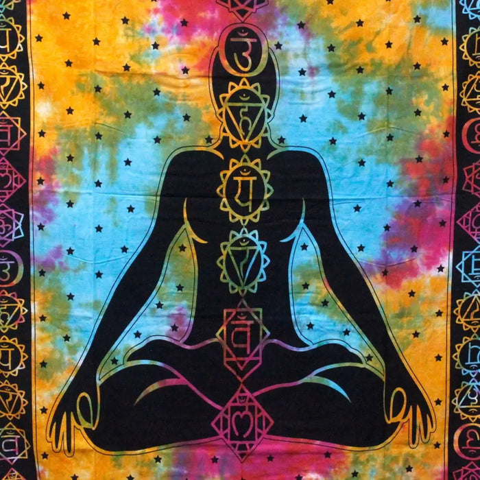 Vibrant tie-dye double cotton bedspread with black meditating figure and rainbow chakra symbols on starry background