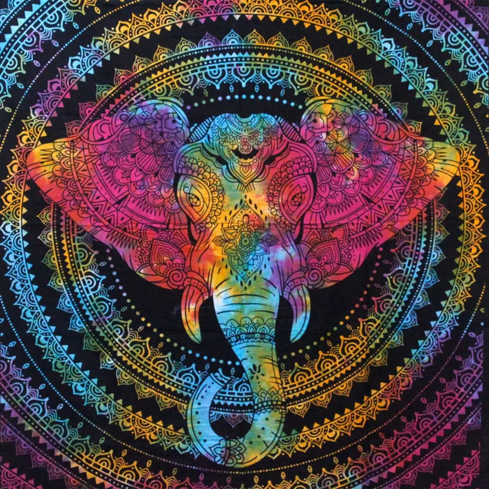 A vibrant rainbow cotton bedspread wall hanging with an intricate elephant head design on a black background