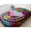 Vibrant rainbow-colored elephant head cotton bedspread wall hanging draped over a bed in a bedroom setting