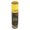 A sleek 8 ml amber glass rollerball bottle of dream spirit perfume oil with a golden cap and black label with gold lettering