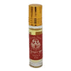 A small clear glass dream spirit roll-on perfume oil bottle with a gold cap and red label for fragrance use