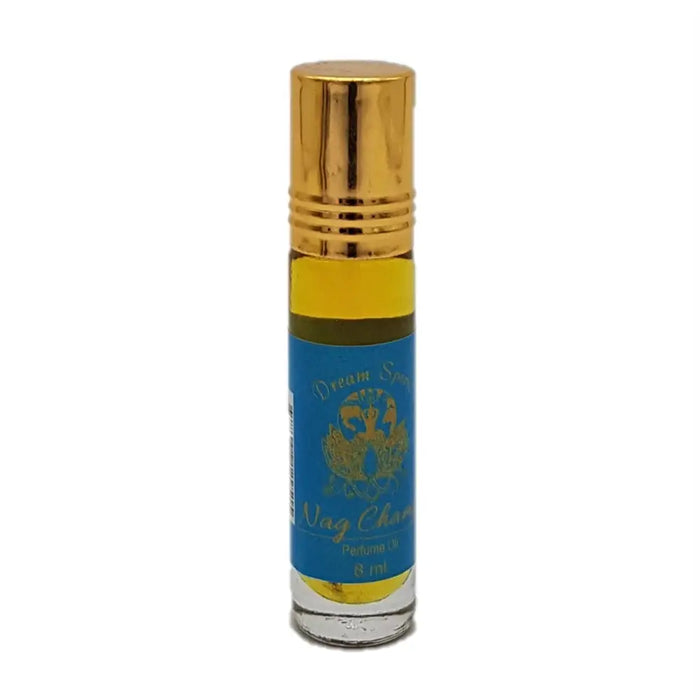 A small glass rollerball bottle of dream spirit perfume oil with gold cap and blue label containing golden-yellow oil