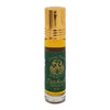 A small clear glass bottle of dream spirit perfume oil with a gold rollerball cap and green label with gold lettering