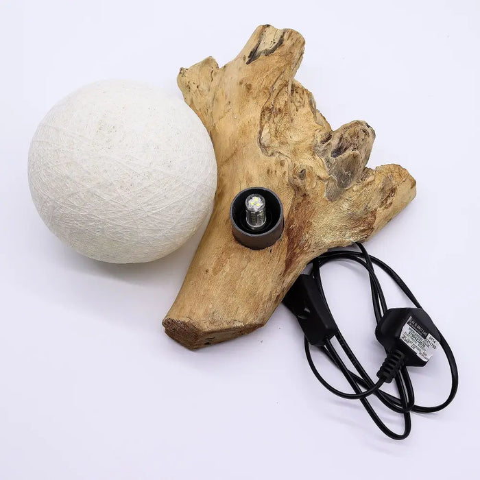 A driftglow lamp with a white cotton wrap shade and textured off-white cotton wrap shade on a natural wood root base
