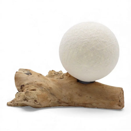 A driftglow lamp with a white cotton wrap shade and textured paper lantern on a natural driftwood base
