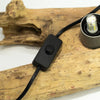 Black plastic toggle switch with matte finish attached to cable for driftglow lamp fibreglass half-moon shade grey