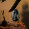 A sleek black crackle lava egg lamp with a grey crackle metallic shade on driftwood for the driftglow lamp collection