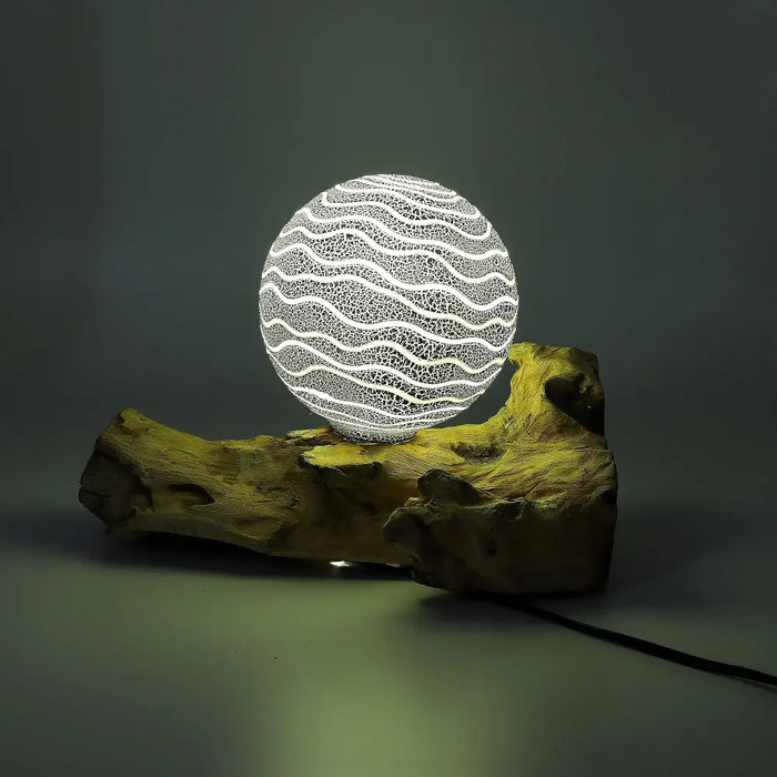A glowing driftglow lamp with grey luna shade features white wavy patterns on a translucent globe with a wooden base