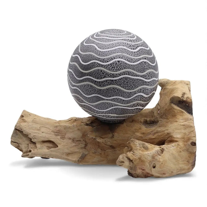 Gray ceramic driftglow lamp sphere with white wavy lines on driftwood featuring grey luna shade design