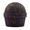 Dark purple bath bomb with gold and green speckles from the dubai bath bomb emerald oudh truffle collection