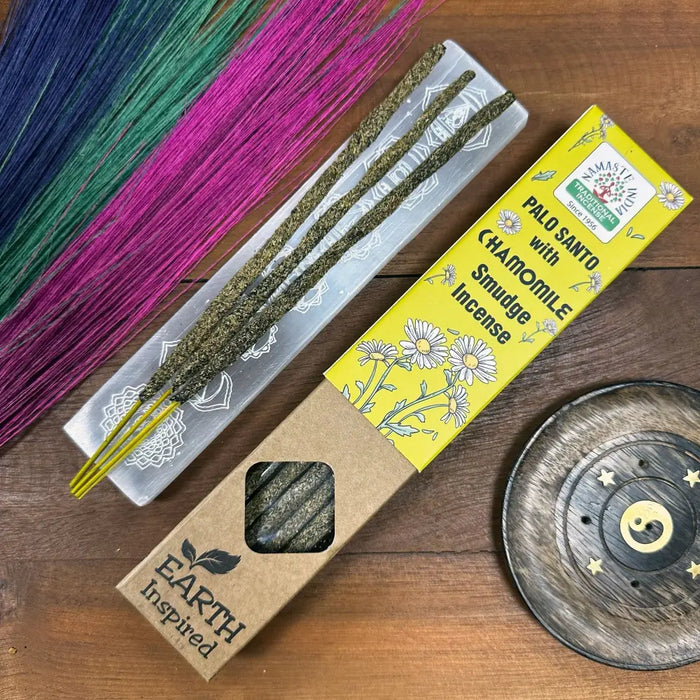 Earth inspired smudge incense with yellow-packaged palo santo and chamomile sticks in a cardboard box