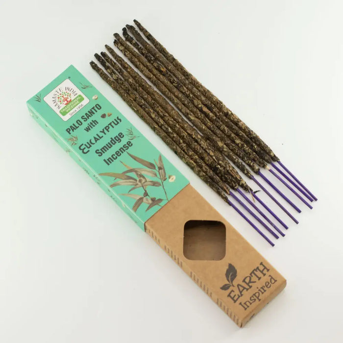 A set of earth inspired smudge incense palo santo sticks with dark brown bark and purple eucalyptus holders