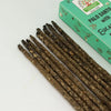 Brown textured palo santo smudge incense sticks with herbal fragments beside a teal earth inspired incense box