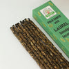 A bundle of dark brown palo santo earth inspired smudge incense sticks with laurel in a green namaste india box
