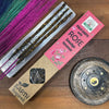 Pink and brown packaged earth inspired smudge incense sticks with palo santo and rose scent in natural setting