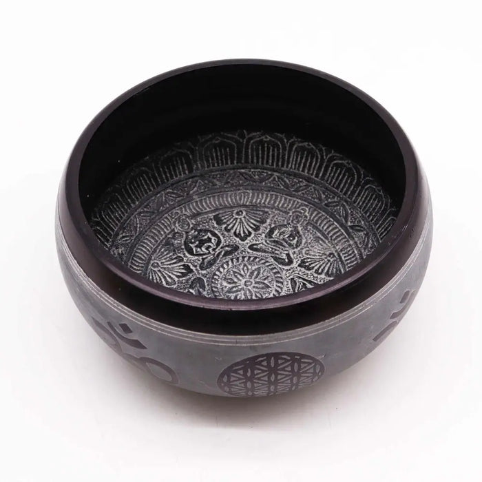 Black hand carved earth powder singing bowl with silver toned five buddha geometric and floral engravings