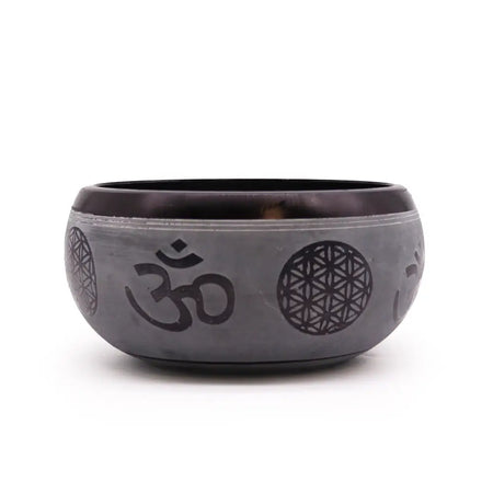 Dark gray metallic earth powder singing bowl with engraved om symbol and flower of life patterns five buddha design