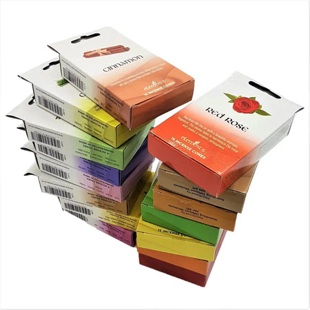 Stack of colorful element brand incense cones boxes in assorted scents like cinnamon and red rose with gradient design