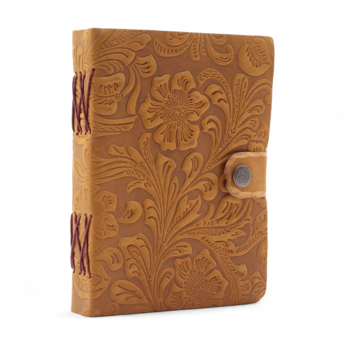Tan leather notebook with embossed floral design and silver button closure shown on a plain background
