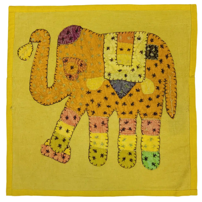 A vibrant indian patchwork cushion cover featuring a yellow embroidered elephant design on a standard cushion
