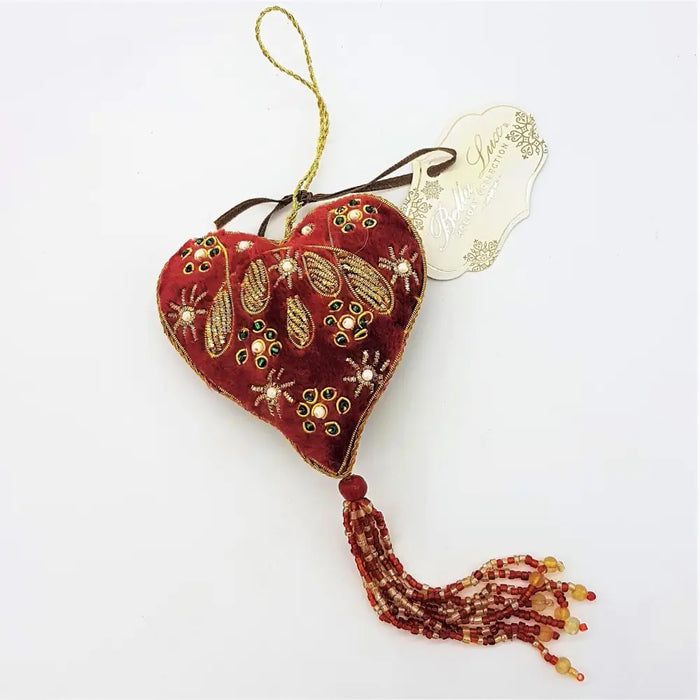 A rich red velvet heart hanging decoration with gold thread embroidery, beads, and a matching tassel