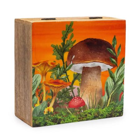 Wooden keepsake box made of mango wood with orange toadstools and green foliage on an orange sky background