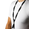 Black lava stone bead necklace with silver buddha head pendant and tassel for grounding energy and natural lava stone benefits