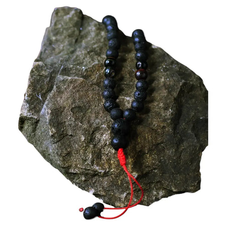 Black lava stone bead bracelet with red cord and tassel for personal transformation and lava stone necklace style
