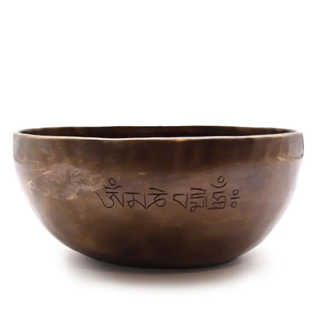 A bronze tibetan singing bowl with engraved sanskrit script along the inner rim extra large indian moon phase design