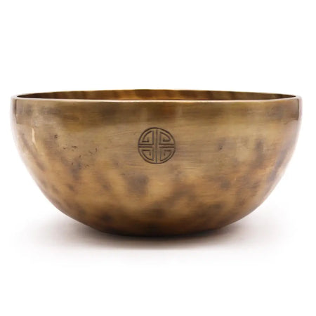 Extra large nepalese brass singing bowl with hand hammered texture and embossed moon design in warm golden hue