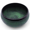 A dark green moss green mushroom singing bowl with hand engraved geometric and facial designs