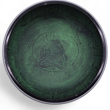 Dark green metal mushroom singing bowl with embossed seated figure and geometric patterns in moss green finish