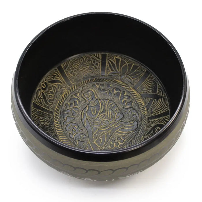 Black extra loud singing bowl with gold embossed meditative buddha and floral geometric designs on metal surface