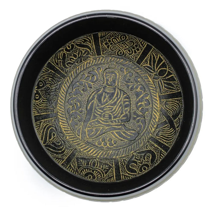 Black circular singing bowl tray with intricate gold embossed buddhist meditative figure and ornate patterns