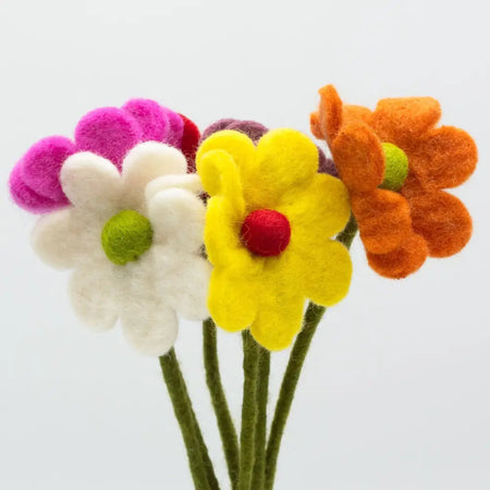 A vibrant bouquet of felt daisies in pink white yellow and orange with green centers handcrafted from felt material
