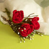 Handcrafted felt flowers showing three red roses with brown stems and small white buds in a simple arrangement