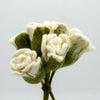 A delicate bouquet of hand-felted white roses with olive green accents made from soft wool fibers
