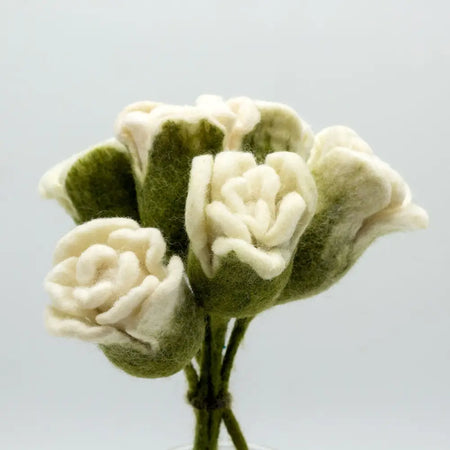 A delicate bouquet of hand-felted white roses with olive green accents made from soft wool fibers