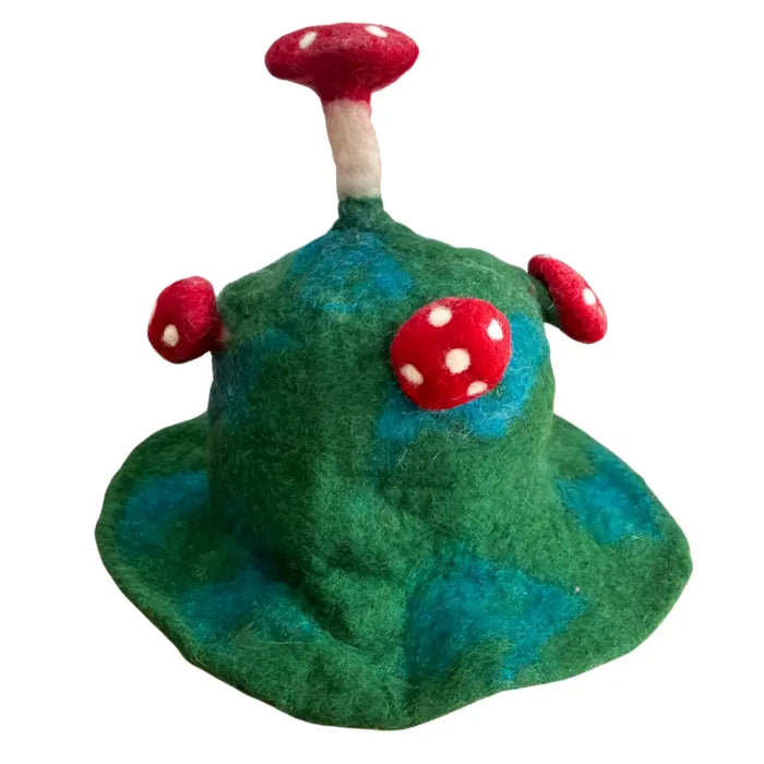 A felted mushroom hat in moss mountain green with a textured felt surface and three red polka-dotted mushrooms