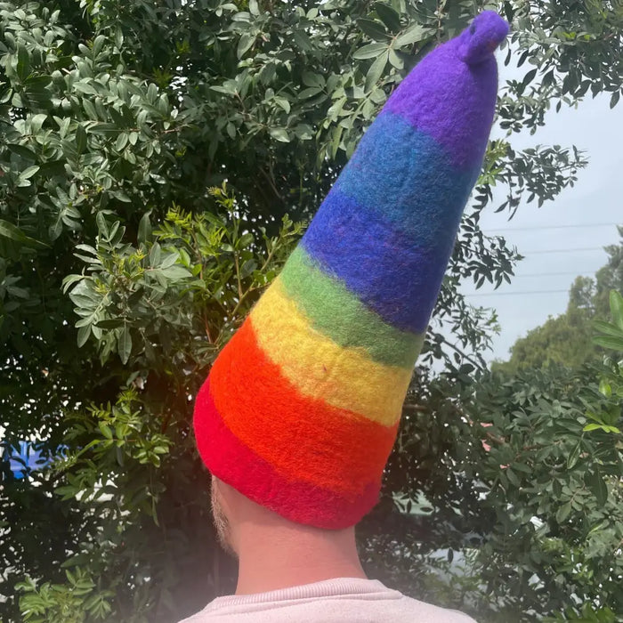A felted sauna wizard hat in rainbow stripes made of soft felt with a pointed top and textured material