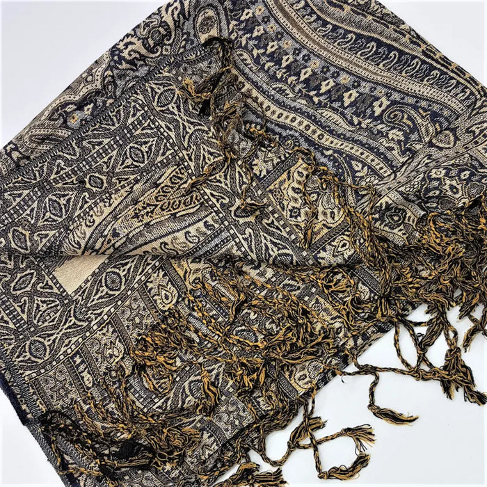 A dark blue and beige pashmina shawl with intricate paisley patterns and fringed edges in fine woven fabric