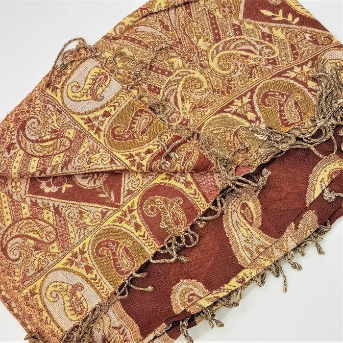 A rust-red and gold paisley patterned pashmina scarf with fringed edges from fine woven pashmina shawls collection