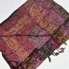 A finely woven pashmina shawl with a burgundy pink gold paisley pattern and fringed edges in rich textures