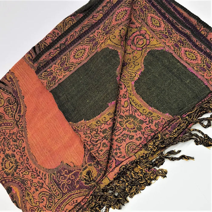 A warm-toned pashmina shawl with intricate paisley patterns in pink orange purple and dark green fringed edges