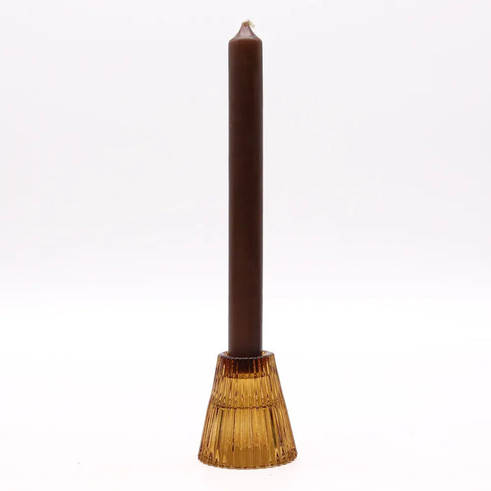 A tall matte brown candle in a textured amber glass tealight holder for dinners and candles decor