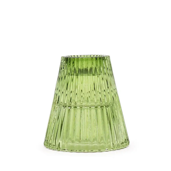 A translucent green glass flip dinner candle holder with a fluted design for tealight candles in garden jade color